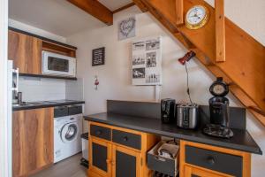 a small kitchen with a sink and a counter top at Emplacement idéal - Trou du Diable sur la Corniche in Les Bussolleries +8 photos