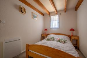 a bedroom with a bed with two pillows on it at Emplacement idéal - Trou du Diable sur la Corniche in Les Bussolleries
