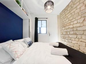 Postelja oz. postelje v sobi nastanitve LE GRACIEUX - MILORA INN - Central Paris
