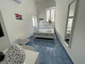 a small room with a bed and a mirror at Villa Spring Apartments in Meta +26 photos