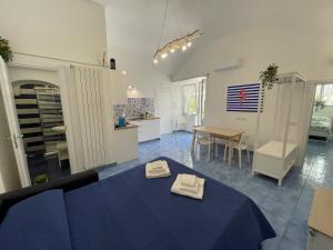 a room with a blue table with two towels on it at Villa Spring Apartments in Meta