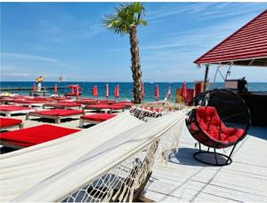 a hammock on a beach with tables and chairs at Одесса Калипсо у Моря на Пляже-однокомнатные апартаменты 24 метра in Odesa