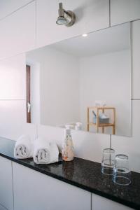 a bathroom counter with towels and a mirror at Hotel Restaurant Nöth in Hammelburg