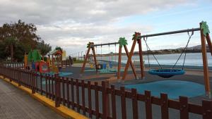 a playground by the water with slides and swings at O Recuncho de Celia in Foz