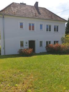 Biały dom z ogródkiem z trawnikiem w obiekcie FAMILY APARTMENT LINZ Wohnen mit Garten am Fusse des Pöstlingbergs TOP LAGE Villenviertel w Linzu