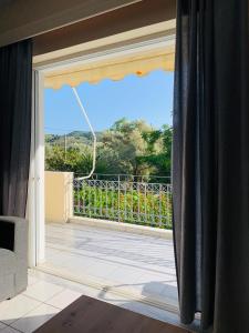 a sliding glass door with a view of a balcony at Olive Tree Apartments in Lefkada Town