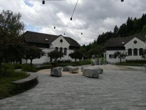 a courtyard with some rocks and some buildings at Apartma Gea, Terme Olimia in Podčetrtek