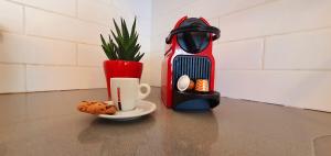 a cup of coffee and a cookie on a table at מלוני דירות נופש אילת - Melony Apartments Eilat in Eilat