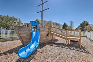 a playground with a blue slide and a cross at Bright, Beautiful Manistee Condo Near Beach and Pool in Manistee