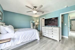 a bedroom with a bed and a ceiling fan at Panama City Condo w/ Balcony & Pool, Walk to Beach in Panama City Beach