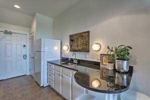 a kitchen with a sink and a refrigerator at Ocean View Condo Btwn Rosemary and Alys Beach! in Rosemary Beach