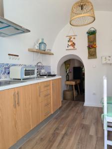 a kitchen with wooden cabinets and a counter top at White Fish Mojacar in Mojácar