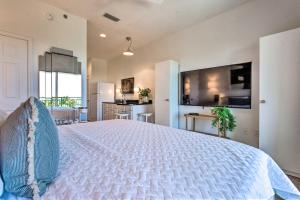a large bedroom with a white bed and a kitchen at Ocean View Condo Btwn Rosemary and Alys Beach! in Rosemary Beach