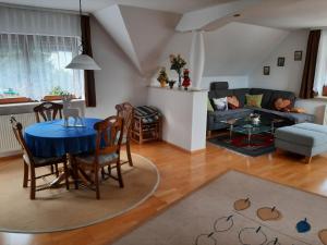 sala de estar con mesa y sofá en Ferienwohnung Serr en Lauf