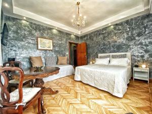 a bedroom with two beds and a table and a chandelier at Ca Nart in Venice-Lido