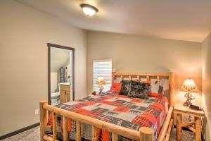 a bedroom with a wooden bed and a mirror at Cozy Cabin - 5 Miles to Mt Rainier National Park! in Ashford