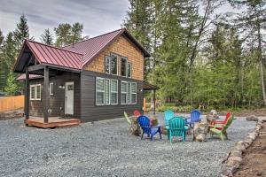 a tiny house with colorful chairs in front of it at Cozy Cabin - 5 Miles to Mt Rainier National Park! in Ashford
