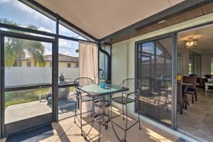 a screened in porch with a table and chairs at Bright Venice Home with Yard Less Than 4 Miles to Beach! in Venice