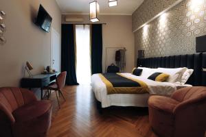 a bedroom with a bed and a desk and two chairs at Mi Hotel Home in Rome