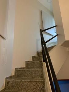 a staircase in a house with a glass railing at Monoambiente Plaza Belgrano in San Miguel de Tucumán