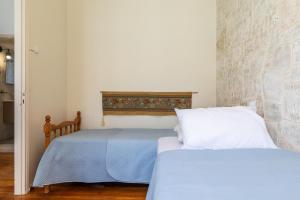 Postel nebo postele na pokoji v ubytování Yiayia's guesthouse