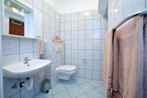 扎達爾的住宿－Pepi Apartments 1，白色的浴室设有水槽和卫生间。