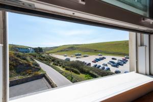 a view from a window of a parking lot at Beachcombers Apartments in Newquay