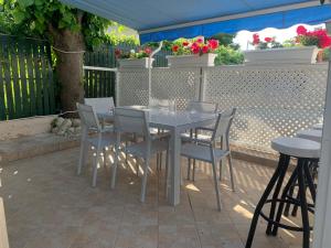 a table and chairs on a patio with flowers at Brother's House in Kallithea Halkidikis
