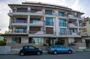 two cars parked in front of a building at Guest apartments STELA in Tsarevo