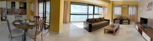 a living room with a couch and a table at Vila Sophia 1 Mamaia in Mamaia