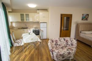 eine Küche und ein Wohnzimmer mit einem Tisch und einem Stuhl in der Unterkunft Guest apartments STELA in Zarewo