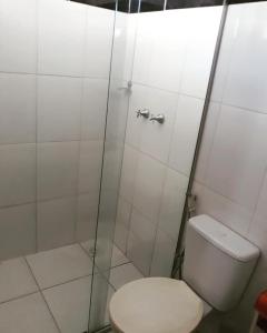 a bathroom with a toilet and a shower at Pousada Surya in Porto Velho