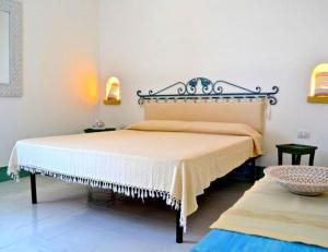 a bedroom with a large bed in a room at Magnificent Villa: SUPER PANORAMIC in Costa Rei