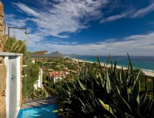 a view of the ocean from a house with a swimming pool at Magnificent Villa: SUPER PANORAMIC in Costa Rei