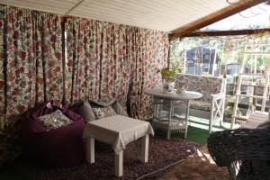 a room with a table and a couch and a table at Kvitkovyi Rai З червня басейн з підігрівом 10 на 5 метрів in Slavske