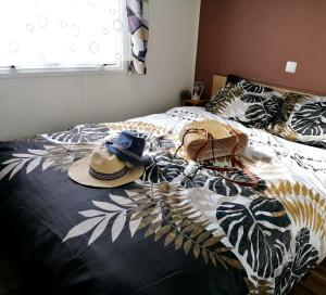 a bed with hats sitting on top of it at la pignade in La Tremblade
