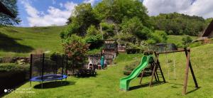 a playground with a slide on a hill at Casa Galet in Pieve Di Ledro