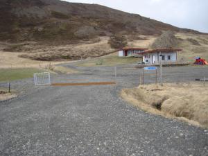 a house on the side of a hill at Ásbrandsstadir Cottages in Vopnafjörður