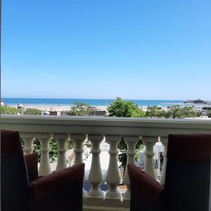 a balcony with chairs and a view of the ocean at Hotel Nuovo Belvedere in Rimini