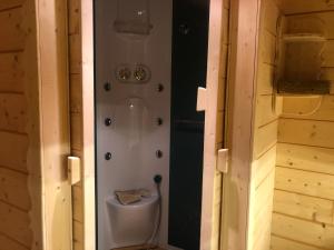 a bathroom with a toilet in the middle of a room at L'Edelweiss in Allos