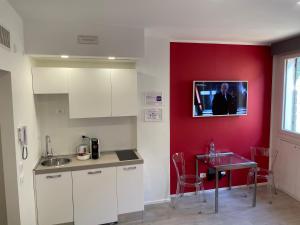 kuchnia ze stołem i telewizorem na ścianie w obiekcie A&F Apartment Padova centro storico w Padwie
