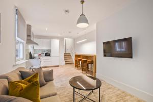 a living room with a couch and a table at Victoria House by Q Apartments in Reading