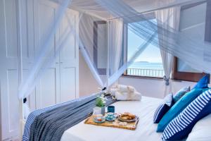 a bedroom with a bed with a tray of food on it at Borgo Eleatico in Casal Velino