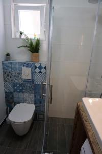 a bathroom with a toilet and a glass shower at Just4Us in Srima +21 photos