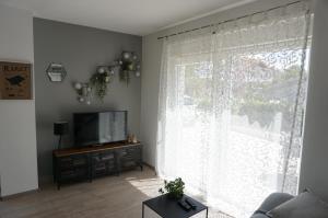 a living room with a large window and a television at Just4Us in Srima