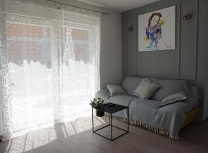 a living room with a couch and a window at Just4Us in Srima