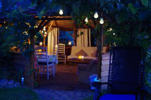 a backyard patio at night with a gazebo at Rodzinne Siedlisko in Biskupiec
