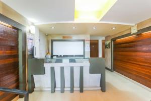 a lobby with a reception counter in a building at Hotel City Garden in Madgaon