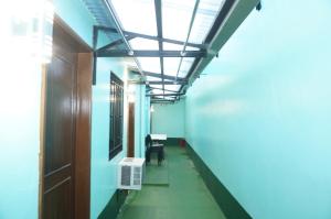 a hallway in an office building with a ceiling at Mint Homes in CEV Mansion in Manila