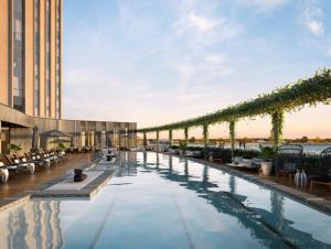 a large swimming pool with a balcony overlooking the ocean at Four Seasons New Orleans in New Orleans